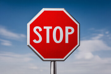 Obraz premium High-Contrast Stop Sign Against Azure Sky A Visual Call for Pause and Awareness