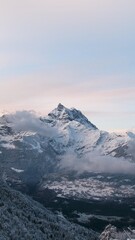 Snow-Capped Mountain Peak under Pastel Sky – Winter Nature Landscape