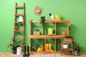 Interior of workshop with gardening tools, shelf unit and ladder