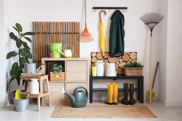 Interior of workshop with gardening tools, plants and rack