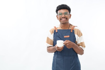 Handsome asian barista serving coffee, bring cup, standing in black apron with friendly smile.