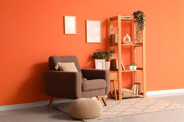 Interior of stylish living room with armchair, table and bookshelf