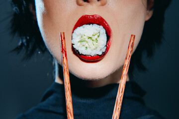 Bold and vibrant sushi experience with a woman holding sushi between red lips and chopsticks,...