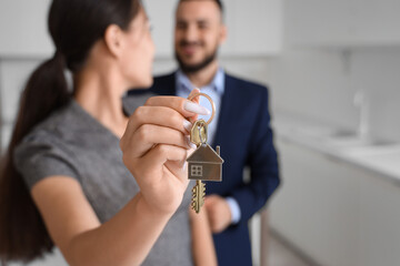 Young couple with key from house in kitchen, closeup