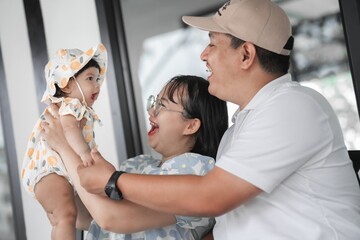 Joyful Family Moment with Baby in Casual Indoor Setting