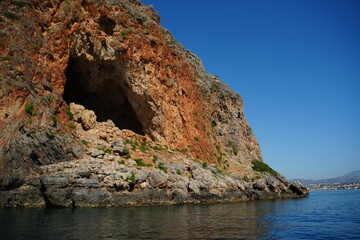 Majestic sea cave nestled in a rocky cliff by the ocean. Rugged geological formations and vibrant...
