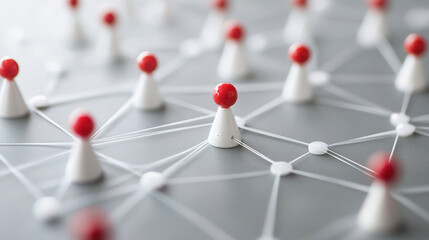A network of interconnected white and red plastic figures on a gray surface.