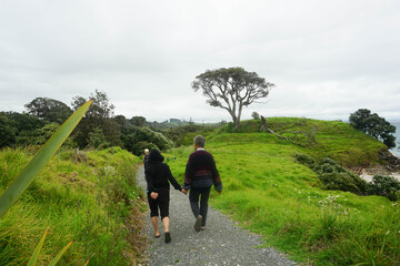 Tourist walking around Waipu pancake rocks in Waipu, New Zealand.	
