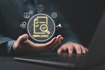 Businessman use laptop with compliance icon on virtual screen. Compliance in business concept. Laws...