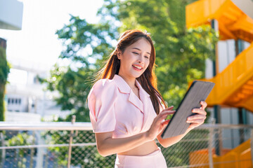 Shot of elegant business woman smiling and using tablet.