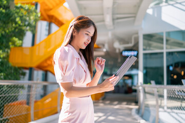 Shot of elegant business woman smiling and using tablet.