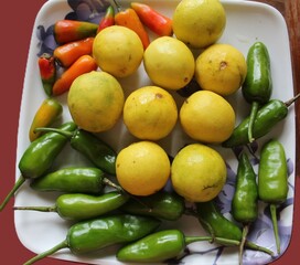 fresh chili, lemon on a plate.