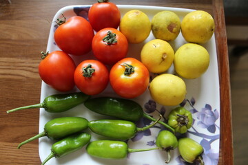 fresh vegetables, tomato, chili, lemon on wooden table