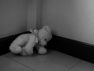 Teddy bear in room, symbol child abuse violence sad domestic kid fear grief emotion sorrow scared...