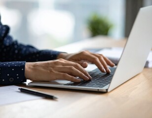 Close-up of a woman's hands typing on a laptop keyboard in an office, engaged in business communication