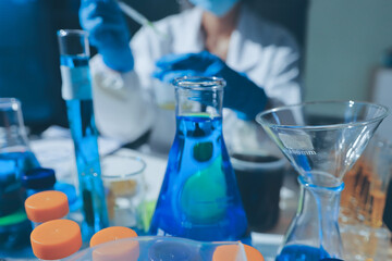 Scientist pipetting medical samples into microplate in laboratory