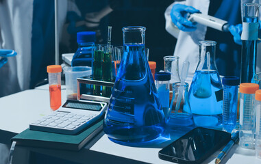 Scientist pipetting medical samples into microplate in laboratory