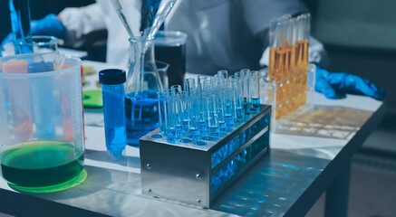 Scientist pipetting medical samples into microplate in laboratory