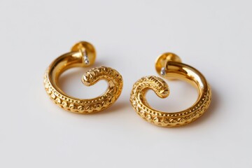 Gold tragus earrings on a white background
