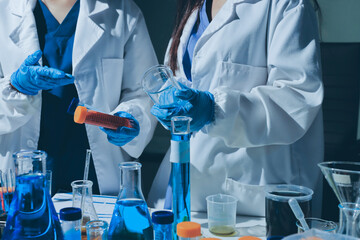 Scientist pipetting medical samples into microplate in laboratory