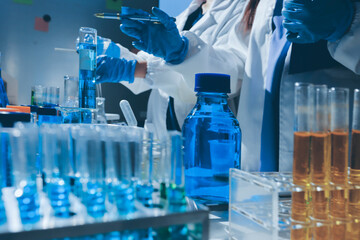 Scientist pipetting medical samples into microplate in laboratory
