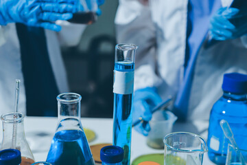 Scientist pipetting medical samples into microplate in laboratory