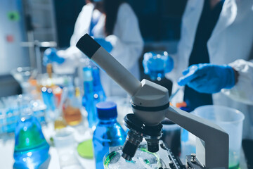 Scientist pipetting medical samples into microplate in laboratory