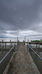 Obraz premium Concrete Pier Under Cloudy Sky