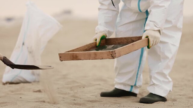 Fuel oil spills on a beautiful seashell beach. Beach oil spill impact. There are many small drops of toxic fuel oil on the shell of the seashore. Environmental pollution. ProRes 422 10bit C-LOG2 video