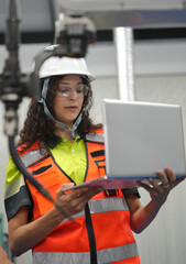 Hispanic engineer woman working on AI technology in robotics electronics engineering laboratory. University students' research project is programming robot machine with intelligent mechanical control