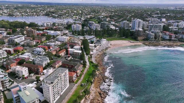Sydney, Australia: Drone Video -Panning along the Esplanade &ndash;the walking trail along the rocky seashore coastline from Cronulla Beach to Sheily Park and Sheily Beach Ocean Pool.