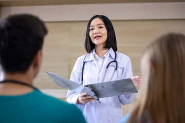 Team of diversity doctor and nurse is discussing and brainstorming on patient medical record after...