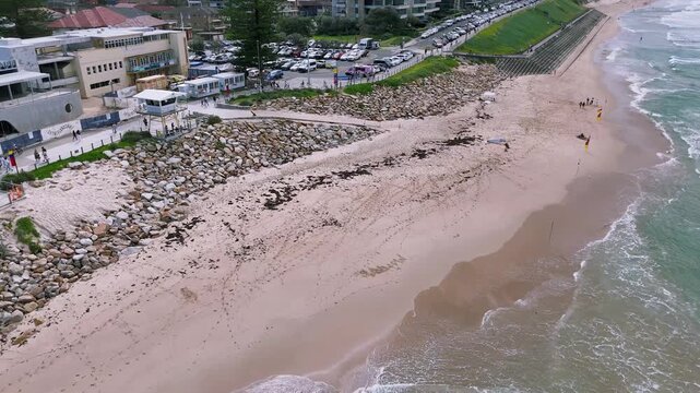 Cronulla, Sydney, Australia &ndash;UHD Drone Video- Panoramic Ocean Views, Surfing and Swimming at North Cronulla Beach with beautiful waves smashing on the rocks.