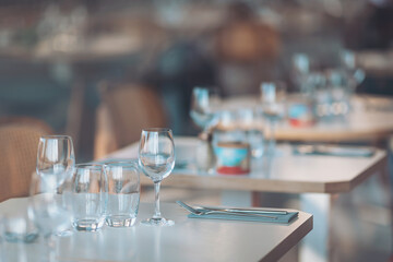 Elegant dining setting in a contemporary restaurant at sunset with beautifully arranged tables and...
