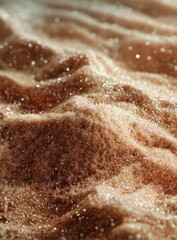 Close-up of textured, glittery, light beige sand