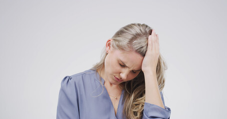 Studio, stress and woman with headache, pain and overwhelmed with regret, thinking and...