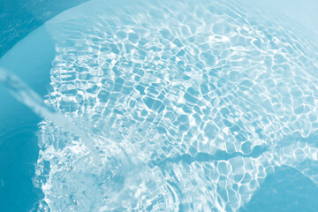 Blue water with ripples on the surface. Defocus blurred transparent blue colored clear calm water...