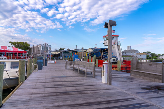 Fire Island, New York State, United States of America. Cherry Grove pier and dock, hotels, bars, restaurants, shops and pride flags.