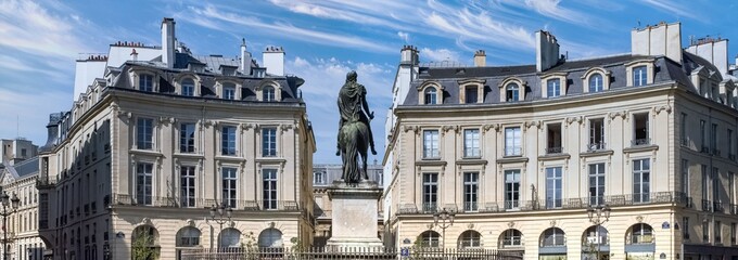 Portrait shot of an equestrian statue on a pedestal.