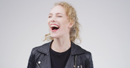 Laugh, happy and face of woman in studio with funny joke, humor or comedy on white background....