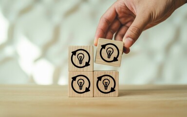 Creative Idea Cycle Hand Arranging Blocks with Innovation Symbols for Problem-Solving and Progress