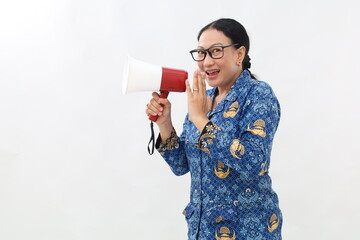 Asian civil servant woman screaming while holding megaphone with hands making announcement