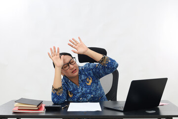 Portrait of Asian civil servant woman looking up and holding hands while looking up into empty...