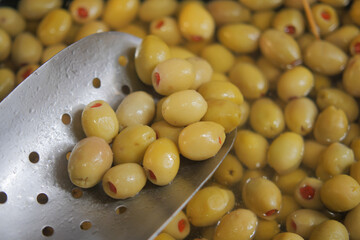 Fresh green olives being prepared for culinary use