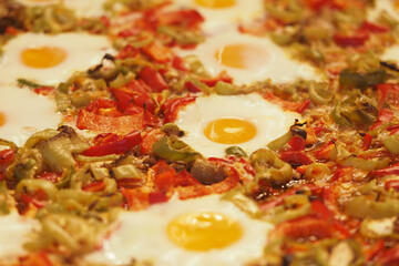 Colorful pizza topped with eggs and fresh vegetables