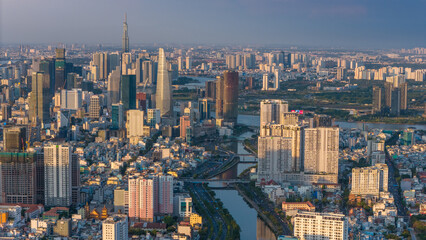 Fototapeta premium Panoramic view of Saigon, Vietnam from above at Ho Chi Minh City's central business district. Cityscape and many buildings, local houses, rivers. Landscape concept.