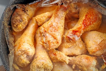 Oven-baked chicken drumsticks removed from roasting bag, showcasing juicy golden-brown results