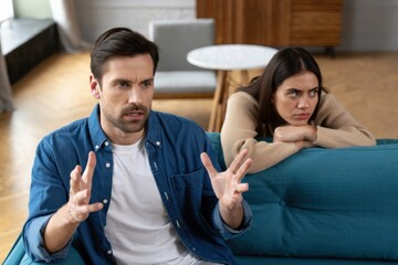 Fototapeta premium A Couple Engaged in a Heated Discussion, One Partner Expression of Frustration, Implying Miscommunication and Emotional Conflict in Their Relationship Dynamics