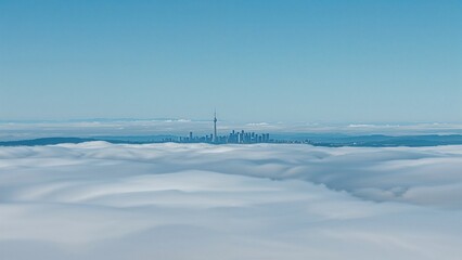 Obraz premium A mesmerizing cityscape emerges from a sea of clouds, with the skylines towers piercing through the fog in a breathtaking aerial view