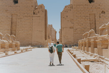 Tourists walking through karnak temple in luxor egypt